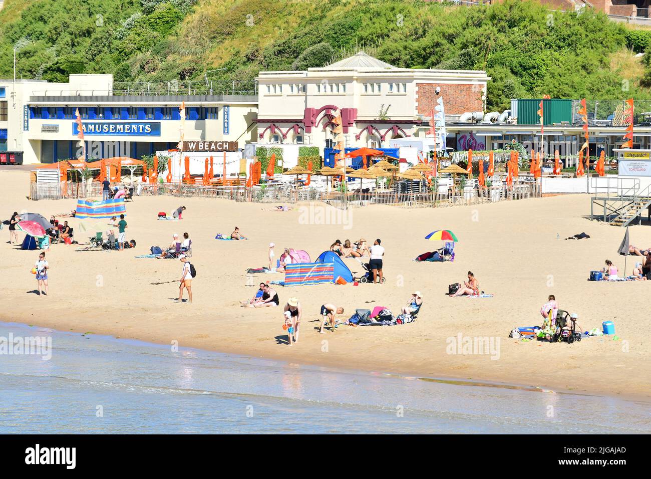 Bournemouth, Dorset, England, UK, 9th July 2022, Weather. Heatwave. People arrive at the beach before 9 am on Saturday morning. Temperatures will reach the high 20s by afternoon in wall-to-wall sunshine. Credit: Paul Biggins/Alamy Live News Stock Photo