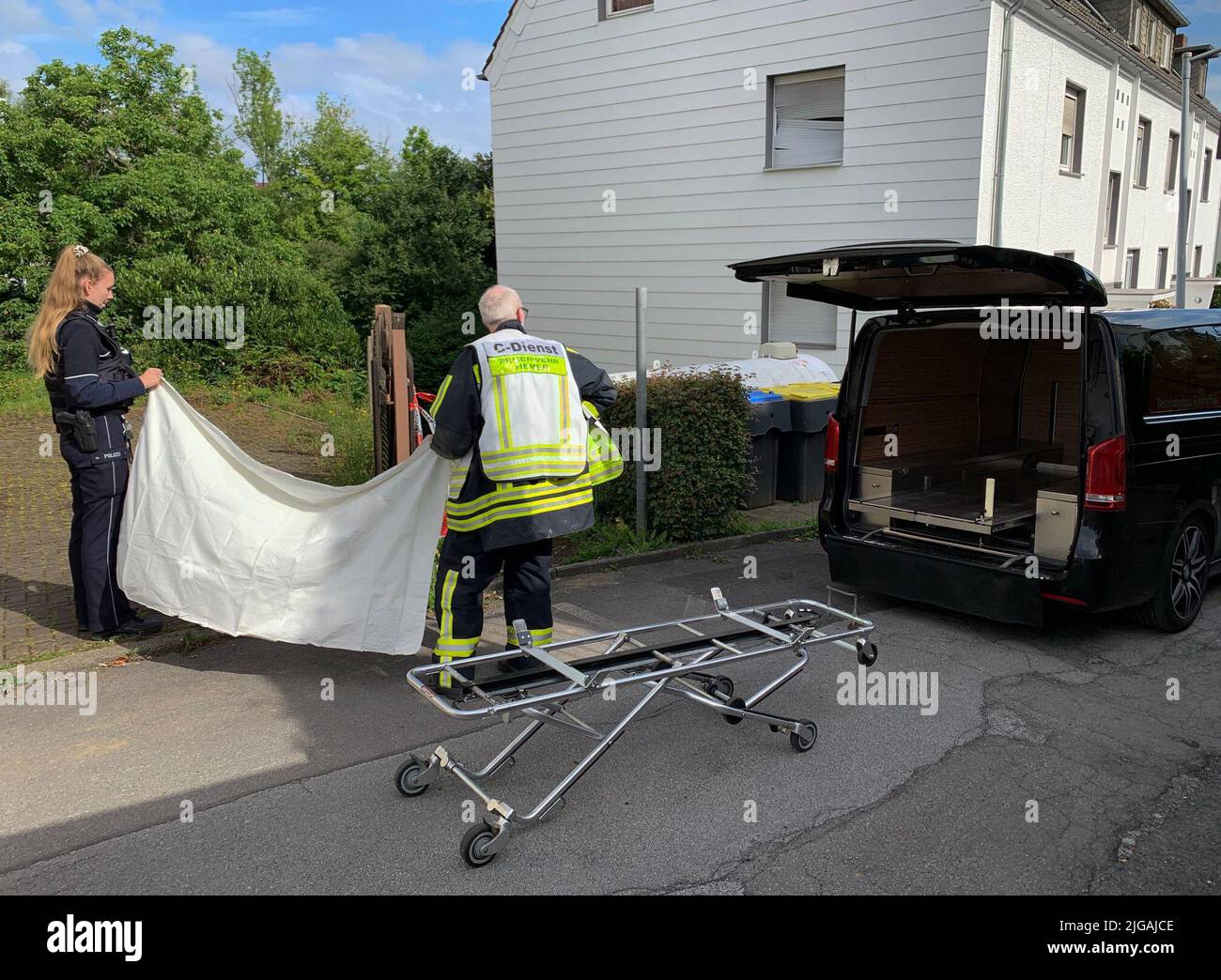 Hemer, Germany. 09th July, 2022. A hearse stands by a road after an explosion in Hemer, Sauerland, caused a multi-apartment building to completely collapse. According to police, rescue workers have recovered a dead woman from the rubble. Credit: Markus Klümper/dpa/Alamy Live News Stock Photo