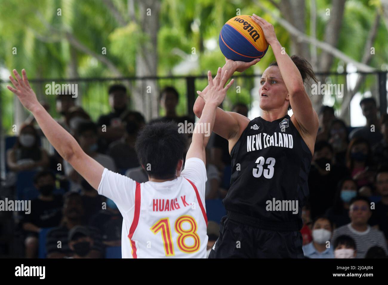 Singapore. 9th July, 2022. Jillian Harmon (R) of New Zealand makes a jump shot over Huang Kun of China during their FIBA 3x3 Asia Cup women's C Pool match in Singapore on July 9, 2022. Credit: Then Chih Wey/Xinhua/Alamy Live News Stock Photo