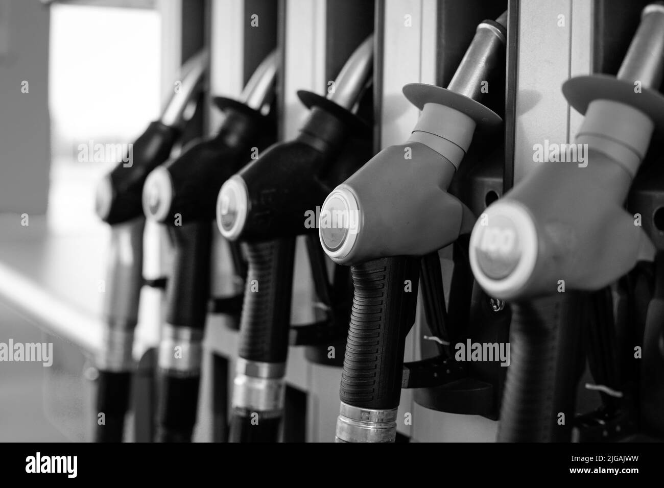 Shallow depth of field (selective focus) details with fuel pumps at a gas station. Stock Photo