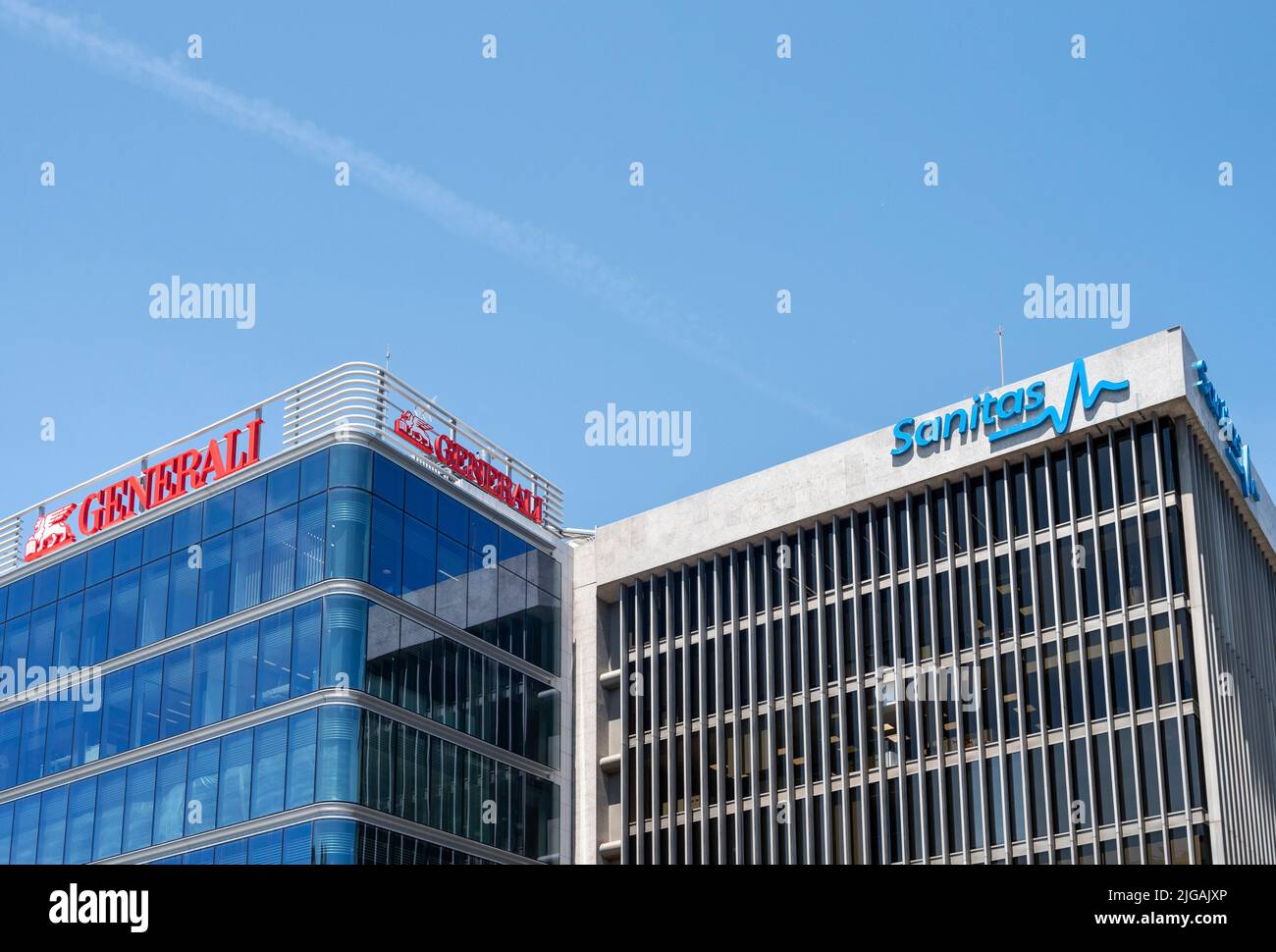 Italian insurance company Generali (L) and Spain's largest healthcare company Sanitas (R) logos