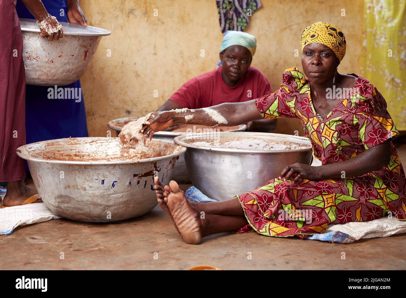 Two black women processing shea butter in a rural village in Ghana Stock Photo Alamy