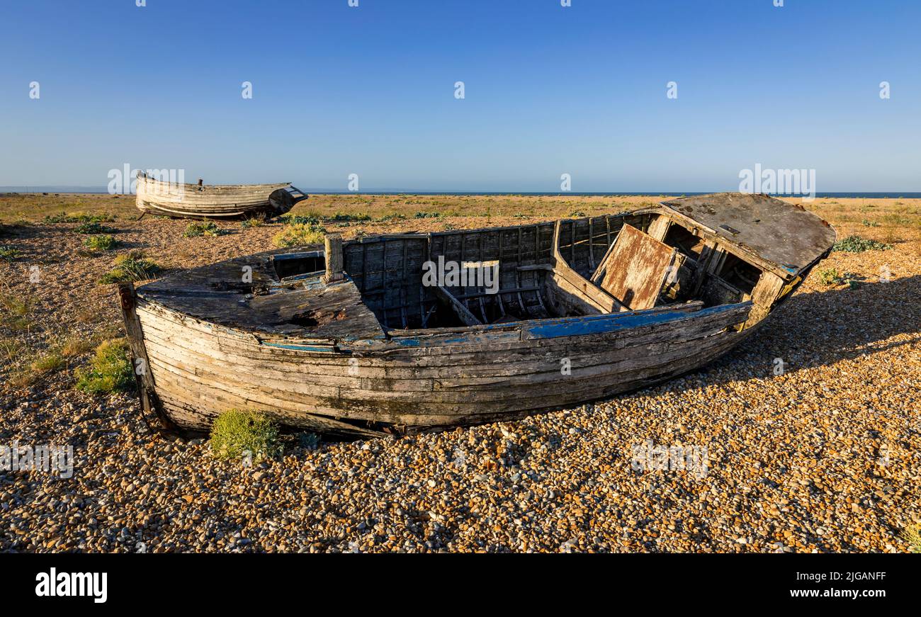 Old wrecked fishing boats on the shingle of Dungeness beach on the Kent ...