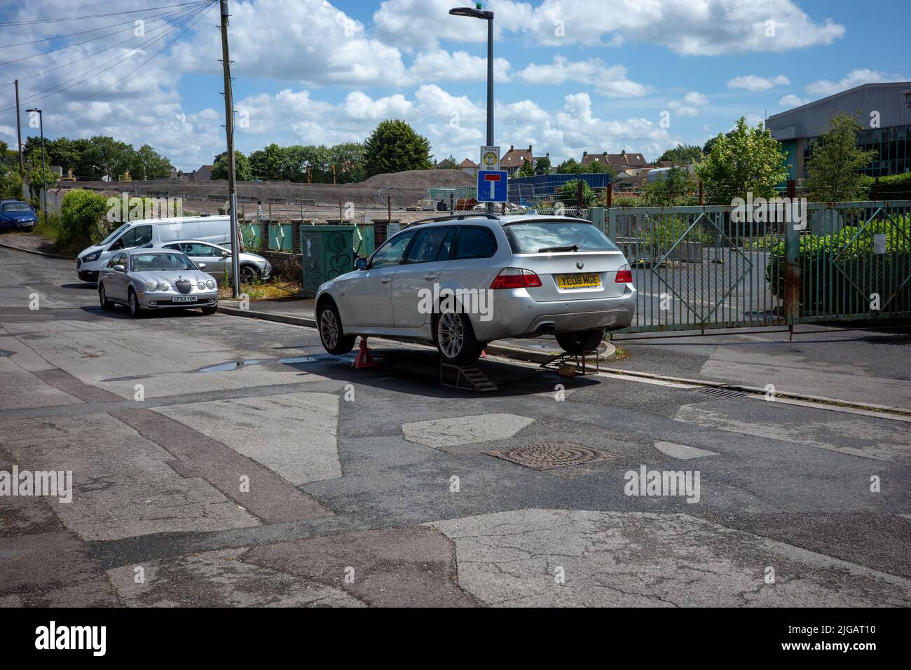 Car abandoned axal stands on the road(Jul22) Stock Photo