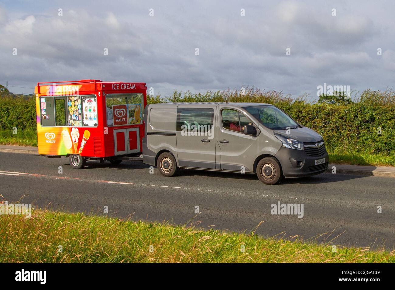 2017 grey Vauxhall Vivaro L1H1 2900 Sportive CDTi BITURBO S/S Van towing mobile ice-cream kiosk; en-route to Hoghton Tower for the Supercar Summer Showtime car meet which is organised by Great British Motor Shows in Preston, UK Stock Photo