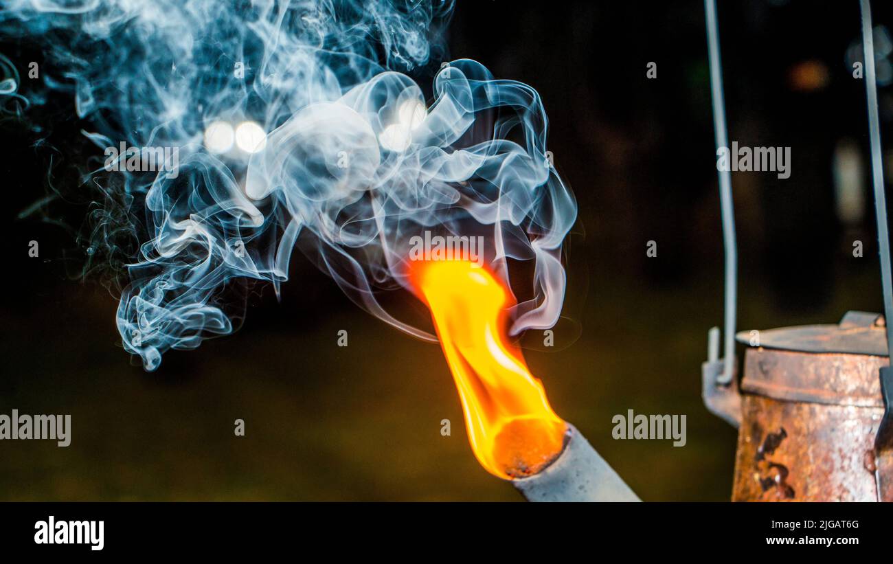 A closeup shot on a kettle gooseneck with fire and steam coming out from the hole Stock Photo