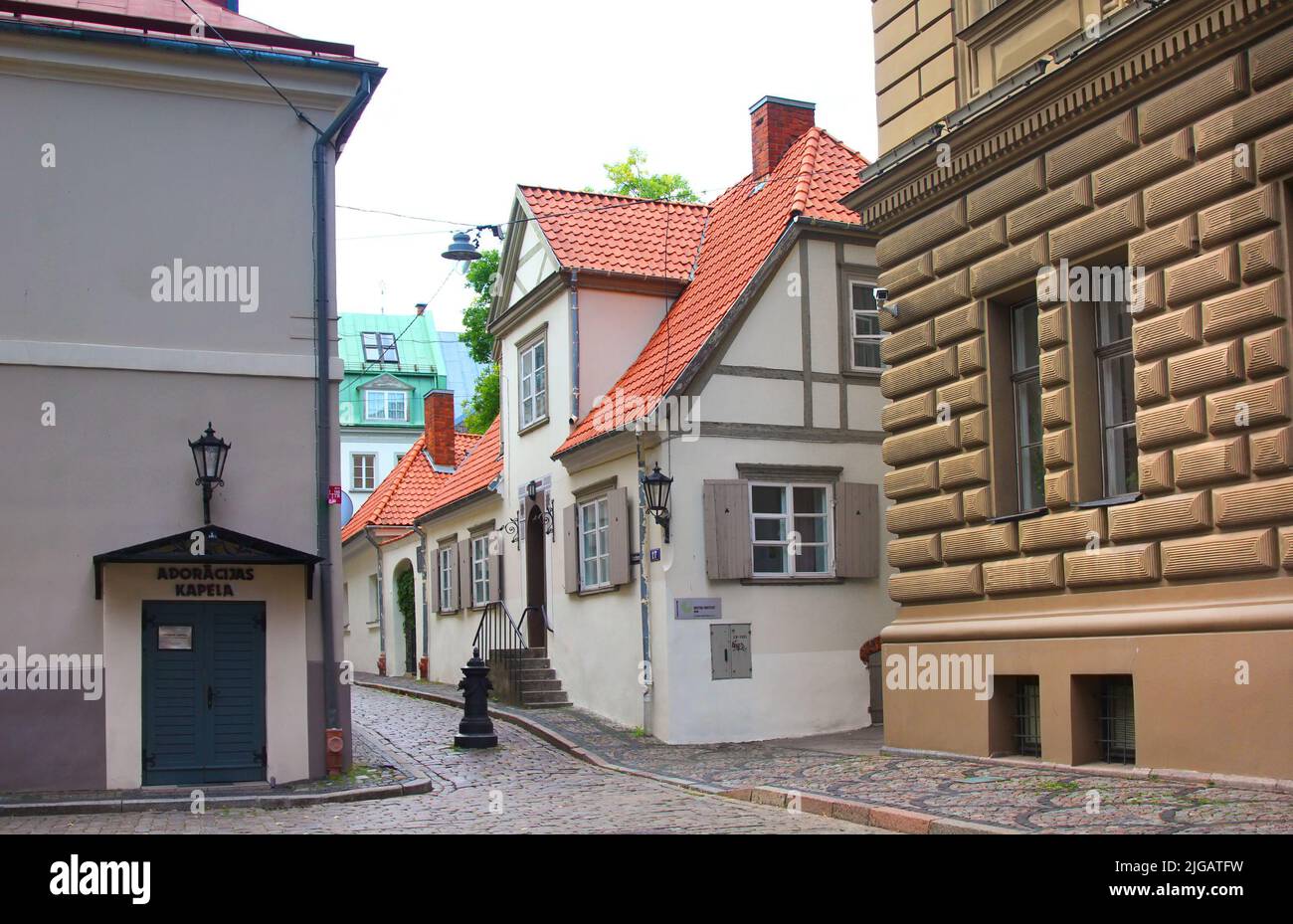 Riga, Latvia - September 10, 2013: Klostera street, a small cozy street with a cobbled pavement in the historical center of the city. Stock Photo