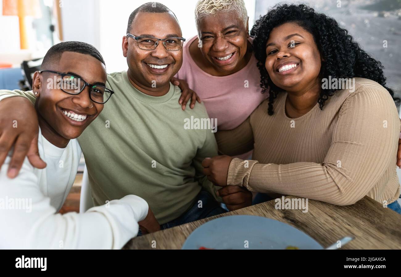 Happy African family having fun after a lunch together at home Stock Photo