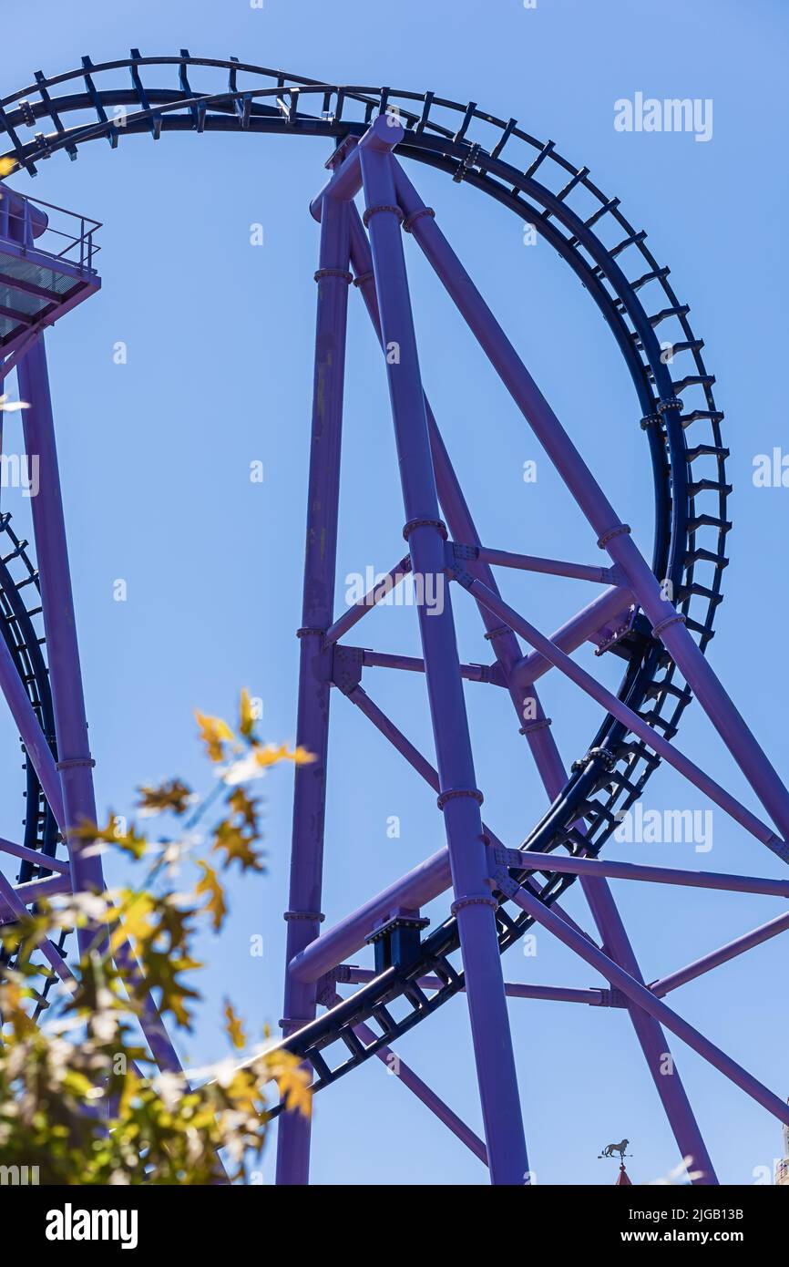 A fragment of purple-blue roller coaster against a blue sky. The most ...