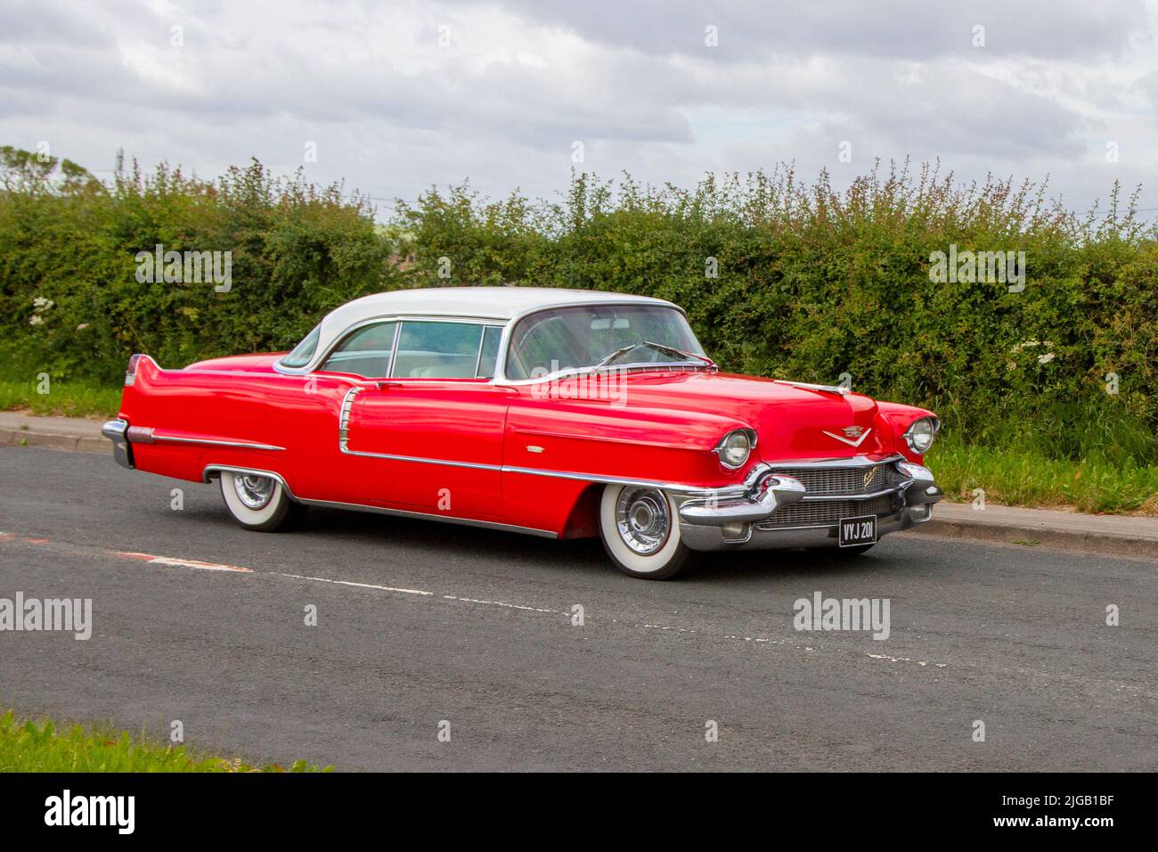 1956 50s, fifties red American CADILLAC Coupe 5700cc muscle car; en-route to Hoghton Tower for the Supercar Summer Showtime car meet which is organised by Great British Motor Shows in Preston, UK Stock Photo