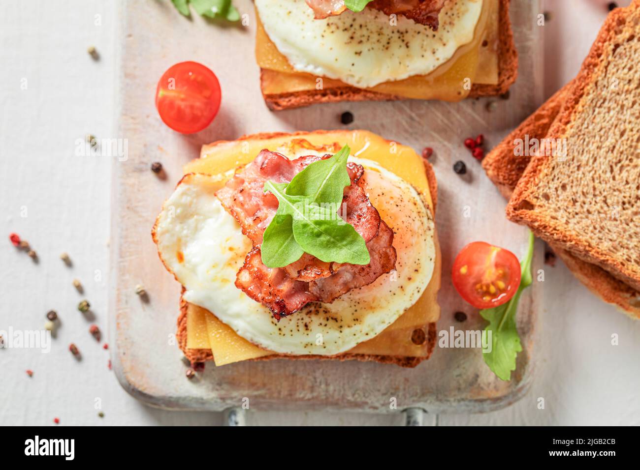 Vegetarian and hot toasts with eggs, tomatoes and bacon. Toasts with