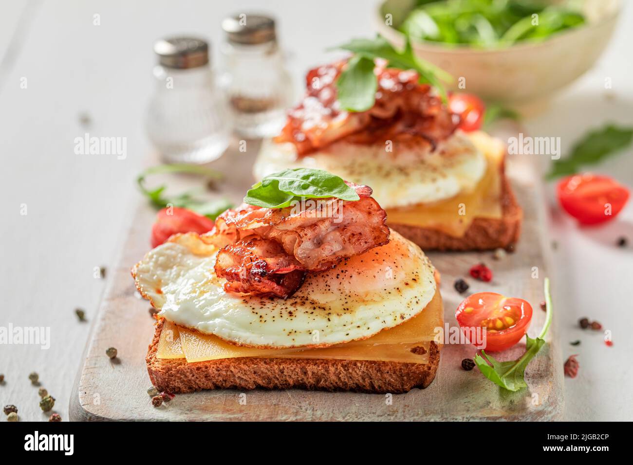 Tasty and fresh toasts with toast, bacon and eggs. Classic breakfast