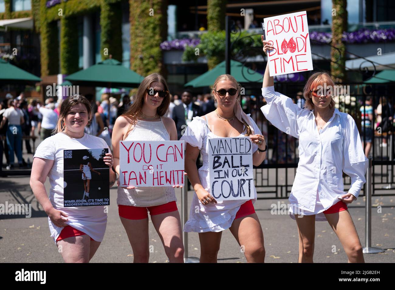 Campaigners from Address The Dress Code outside the main gate at