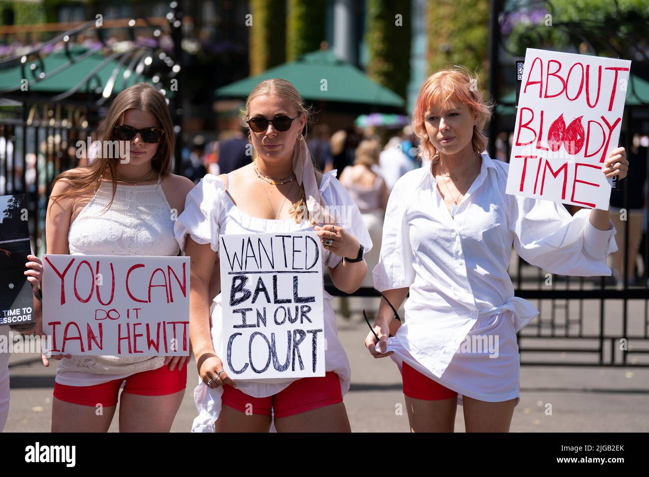 Campaigners from Address The Dress Code outside the main gate at