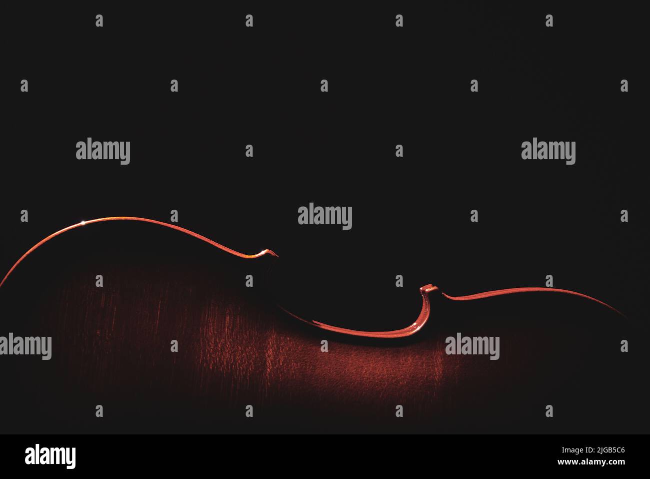 part of a violin on a black background with hard light Stock Photo - Alamy