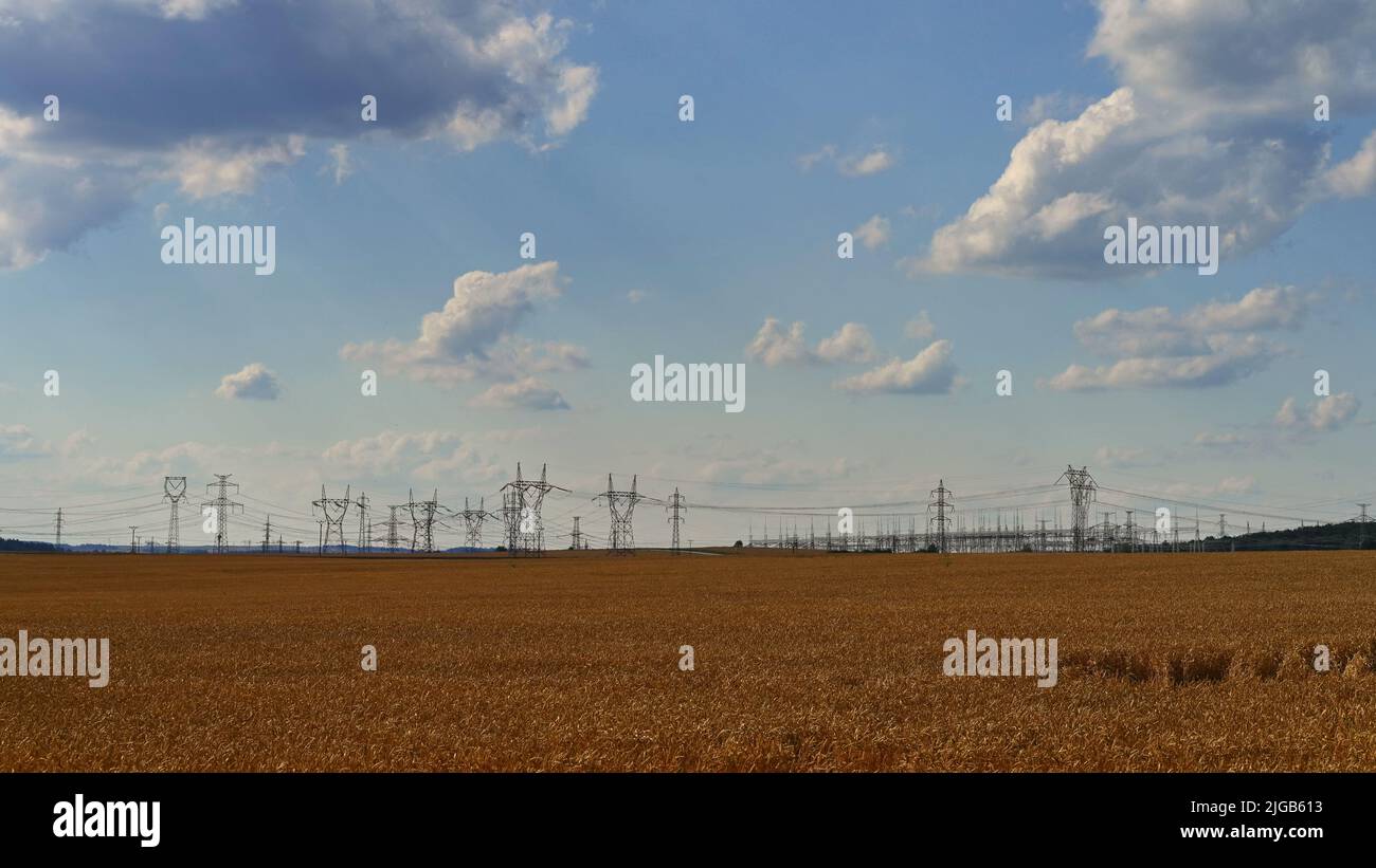 High voltage pylons - Blue sky with clouds and sun in nature. Concept ...