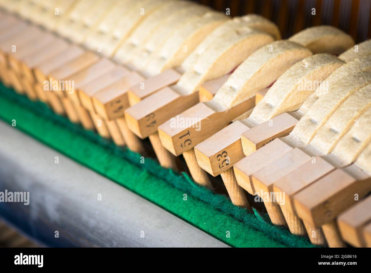 Lined up hammers of an upright piano Stock Photo