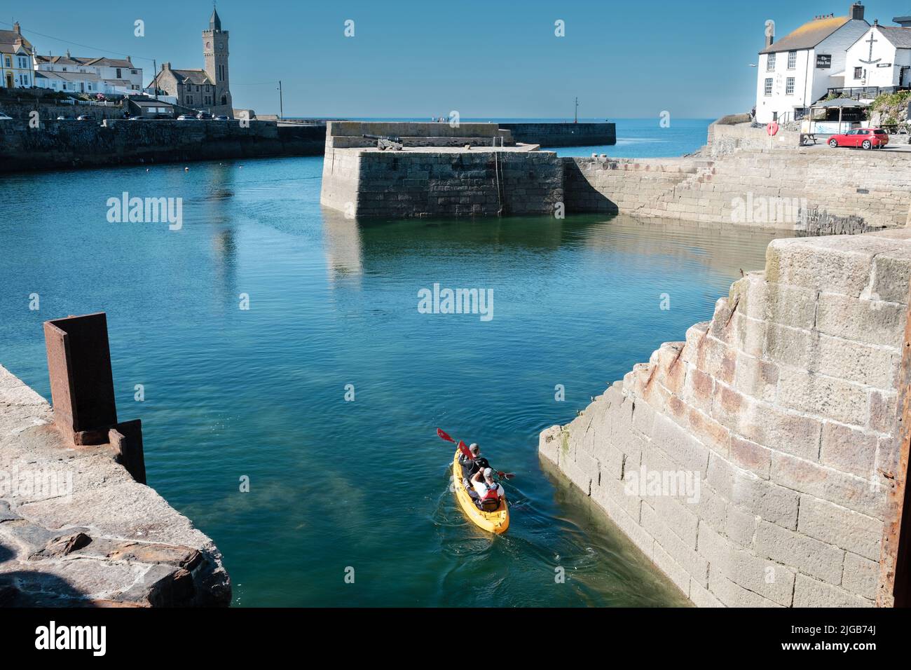 Kayak leaving harbour in Porthleven, Cornwall Stock Photo