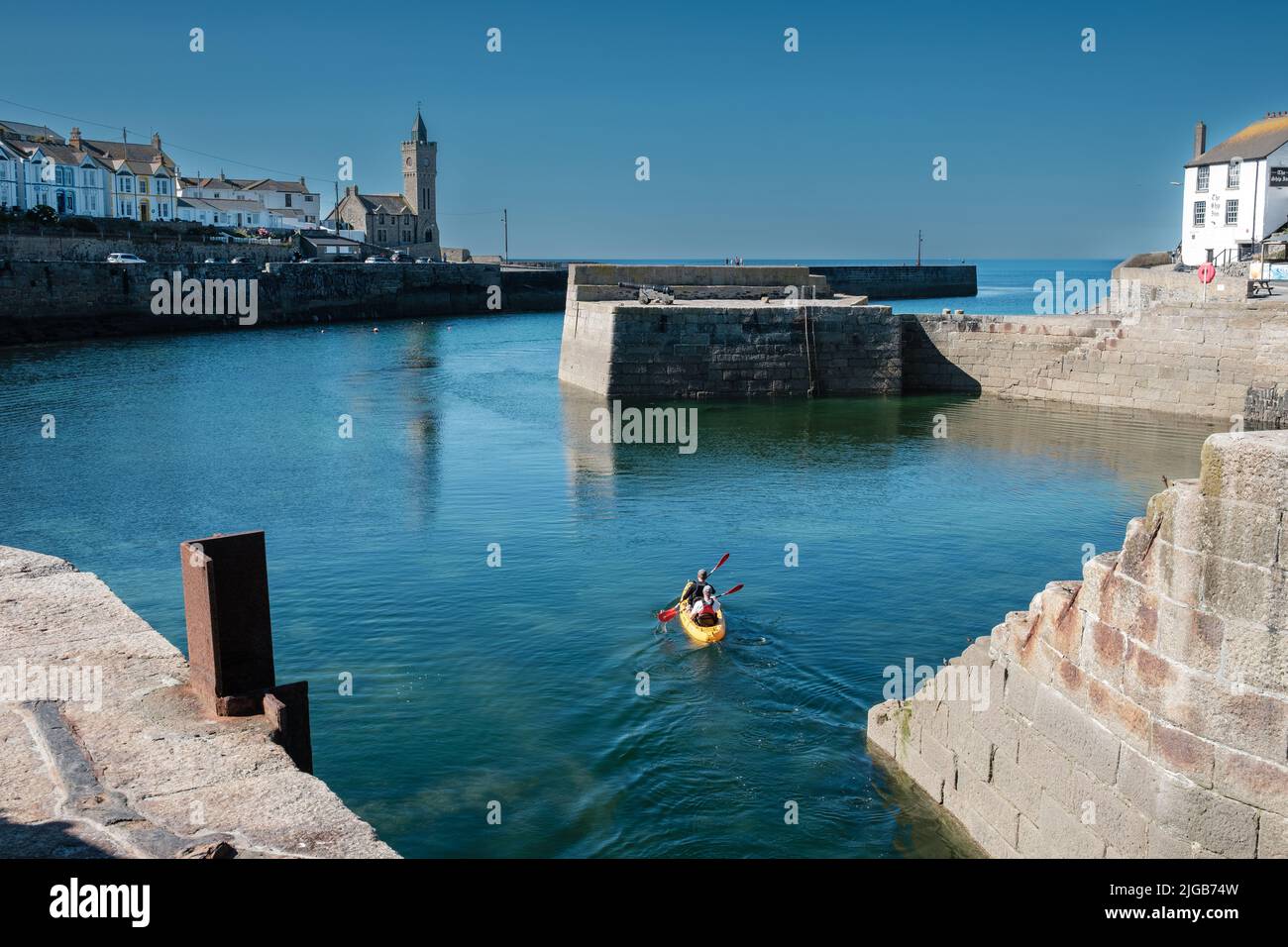 Kayak leaving harbour in Porthleven, Cornwall Stock Photo