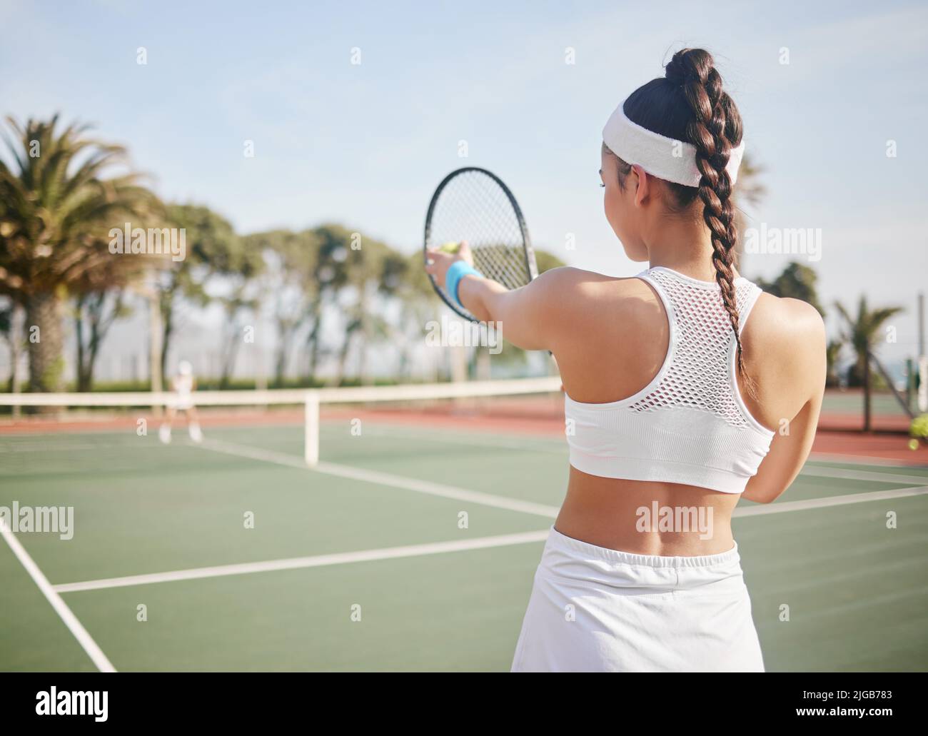 I know exactly where I want this ball to go. an unrecognisable tennis player standing on the court and getting ready to serve during practice. Stock Photo