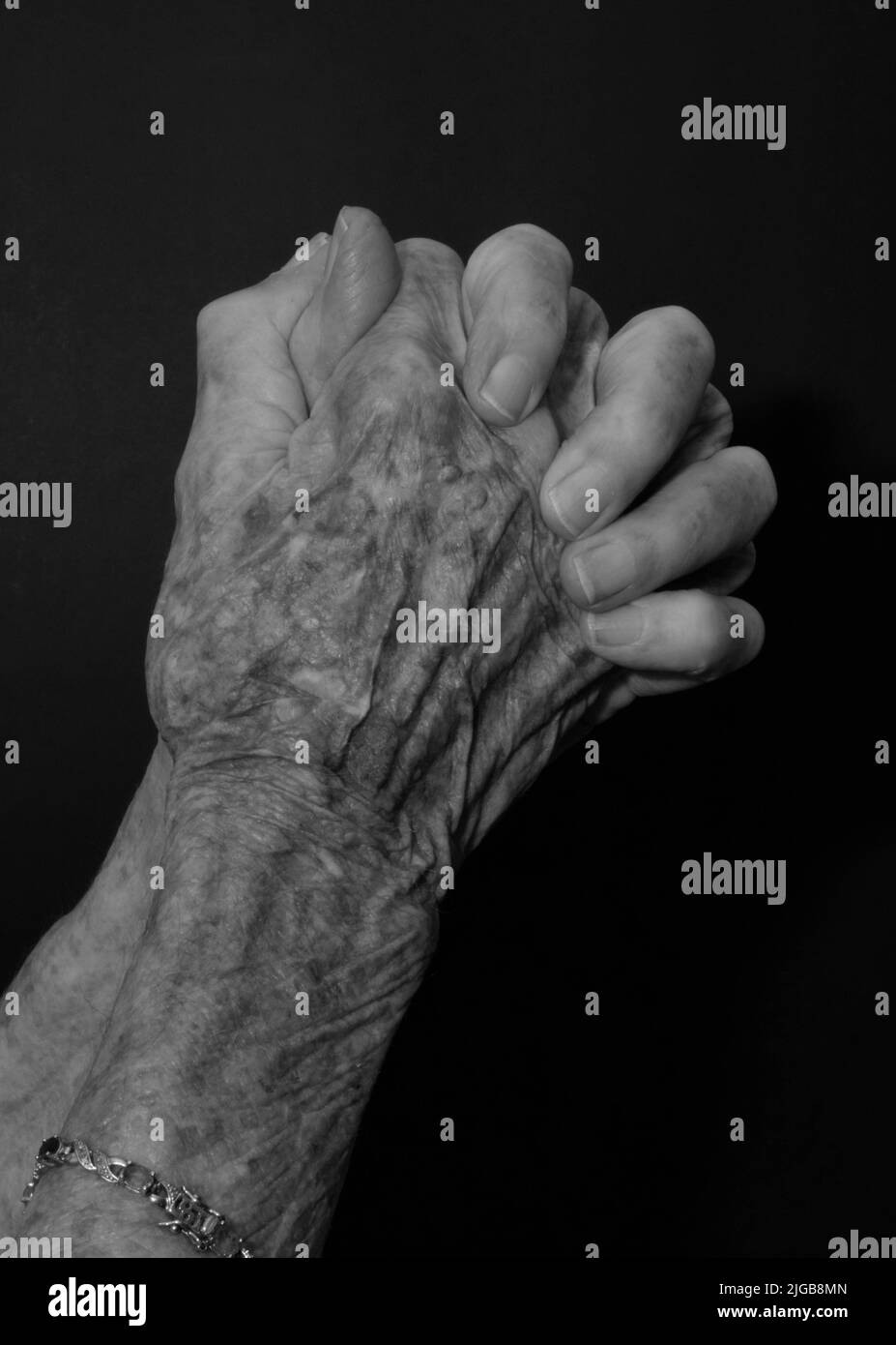 An old hands praying isolated on a black background Stock Photo Alamy