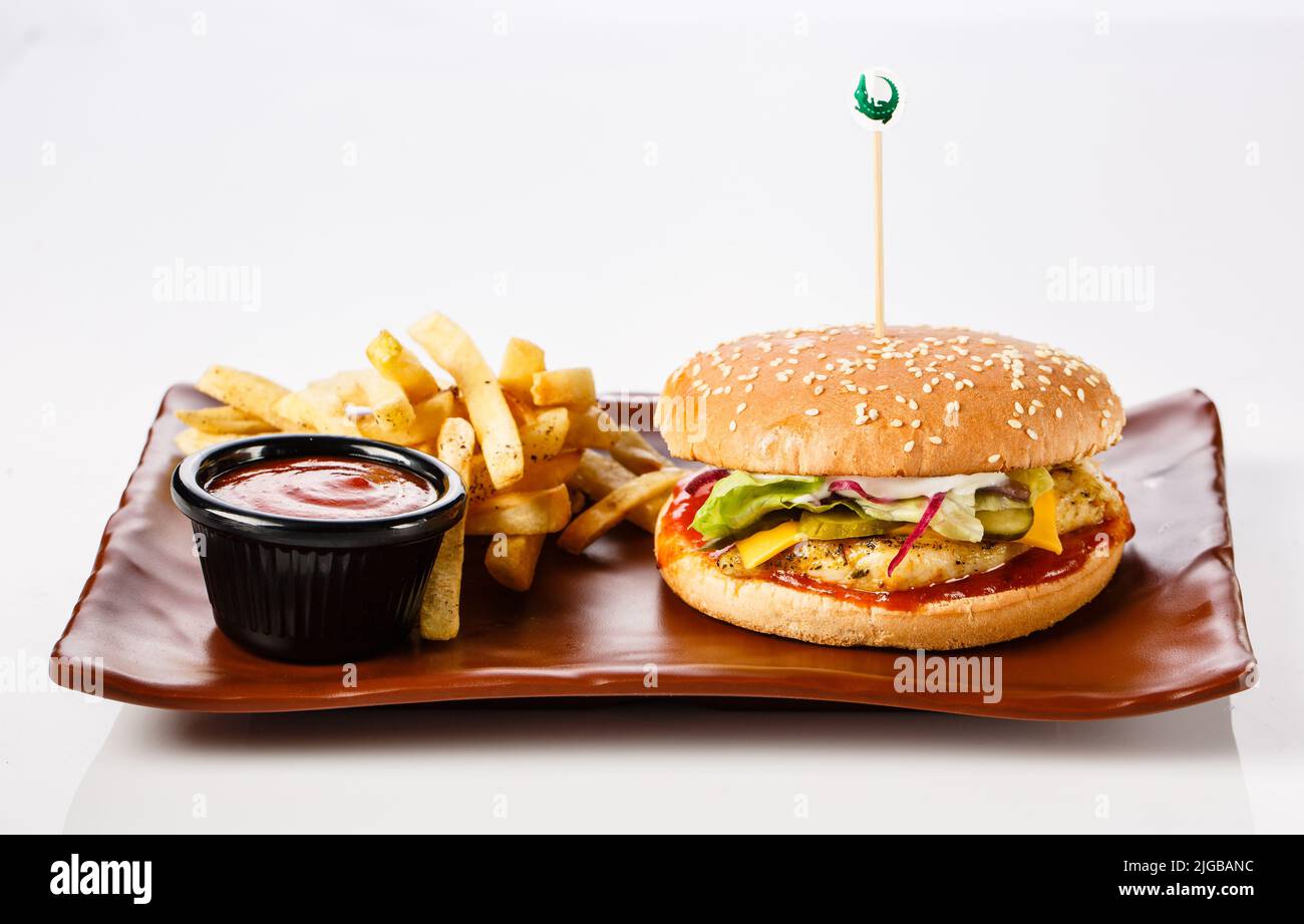 Burger. Juicy pork cutlet, cheddar cheese, crispy pickled onions, lettuce wrapped in a bun under