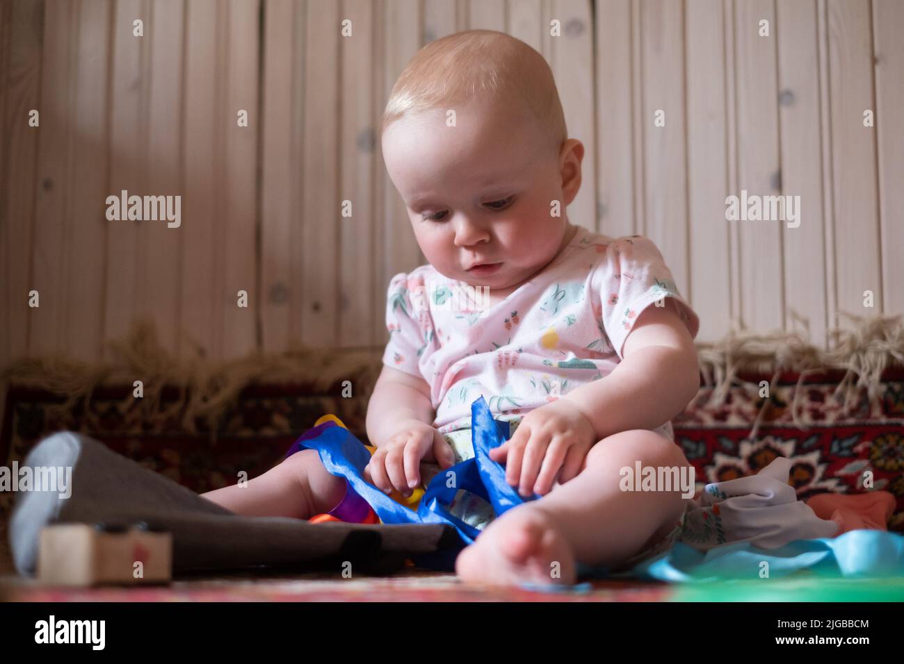 baby girl playing with toys at home alone Stock Photo