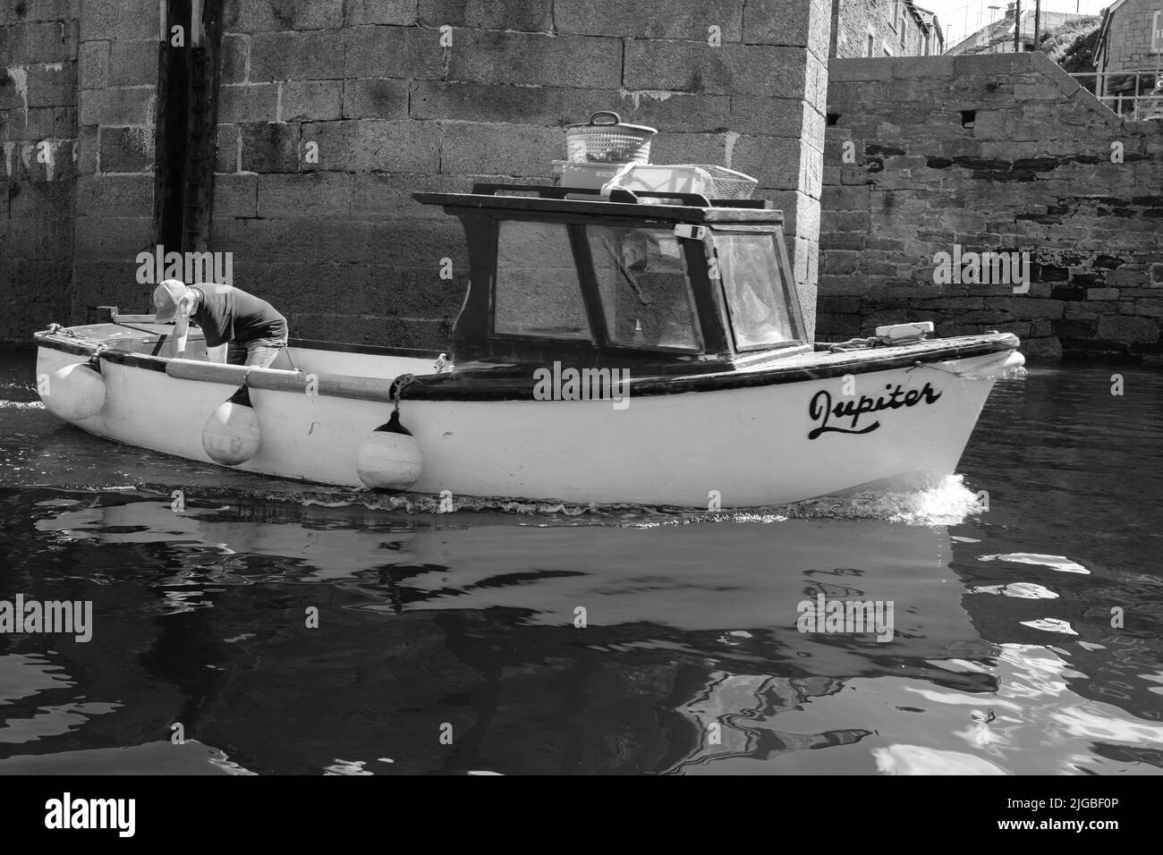 Boats leaving Porthleven Harbour, Cornwall Stock Photo