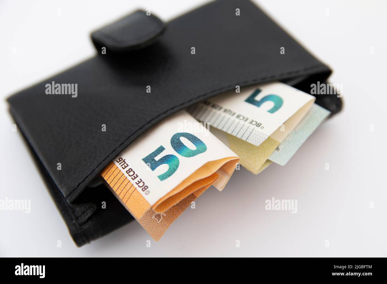 Closeup of euro banknotes sticking out of a wallet Stock Photo