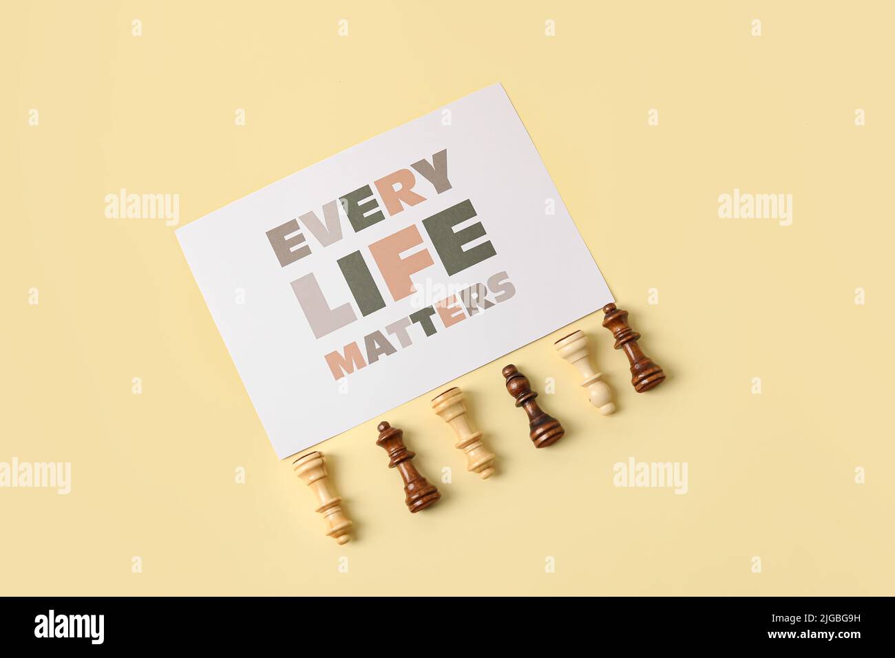 Chess pieces and paper sheet with text EVERY LIFE MATTERS on light ...