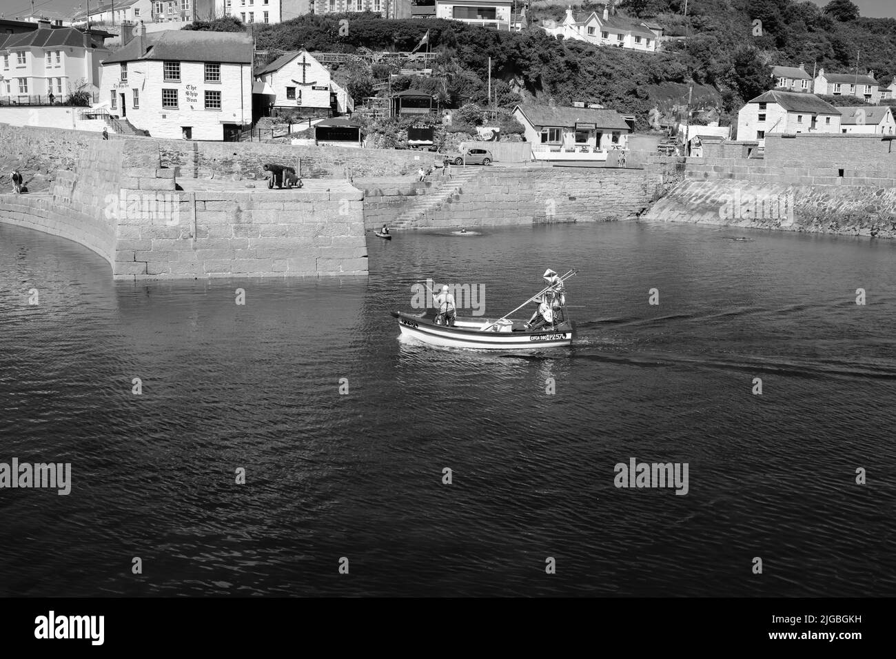 Boats leaving Porthleven Harbour, Cornwall Stock Photo