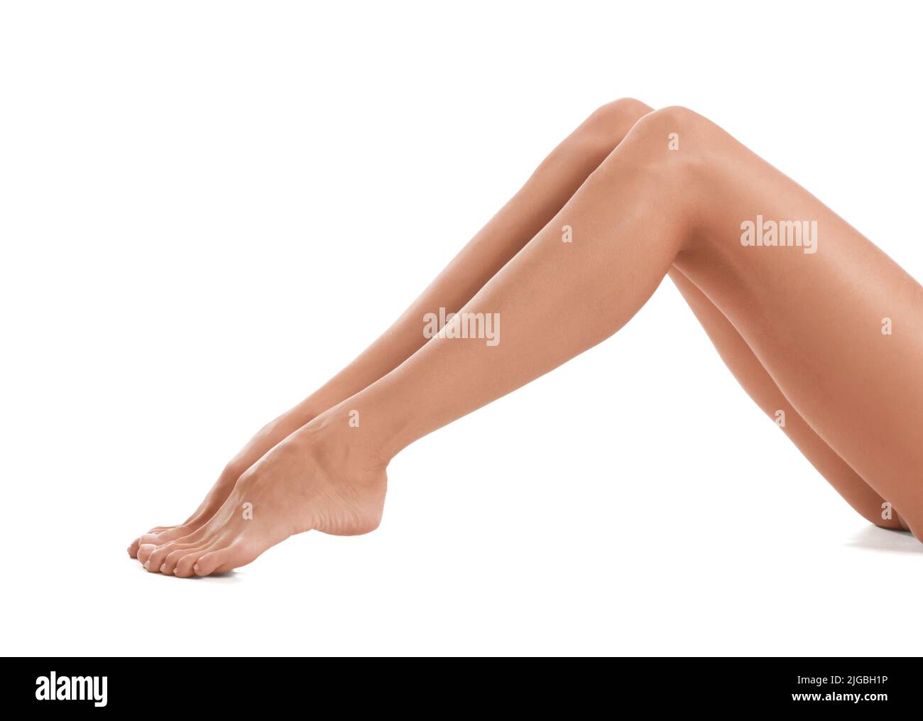 Tanned legs of young woman on white background Stock Photo
