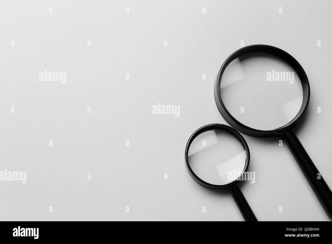 Magnifying glasses on light background Stock Photo Alamy
