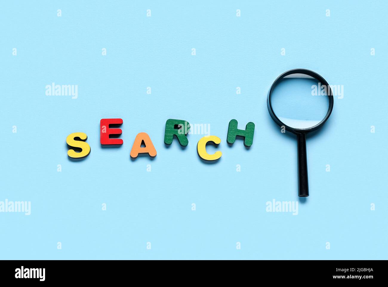 Word SEARCH and magnifying glass on light blue background Stock Photo ...