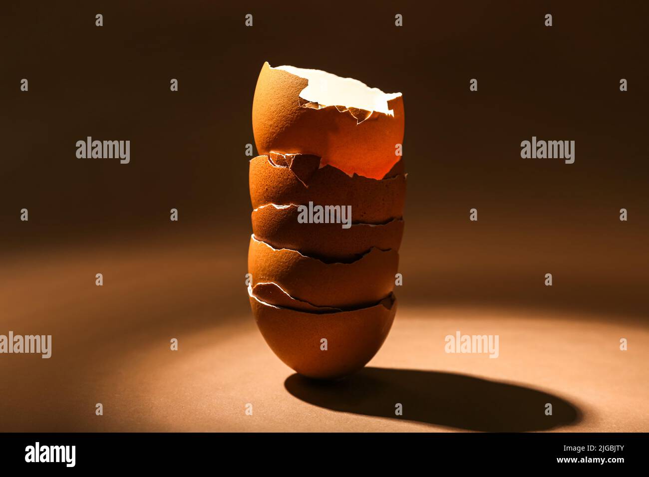 Stack of broken egg shells on dark color background Stock Photo