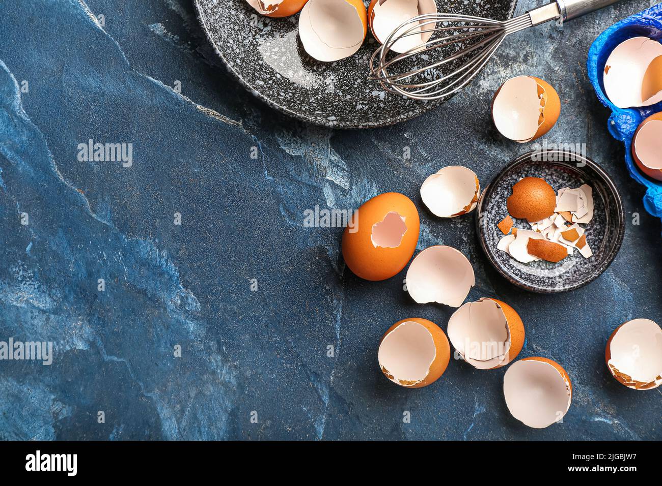 Composition with broken egg shells on color background Stock Photo