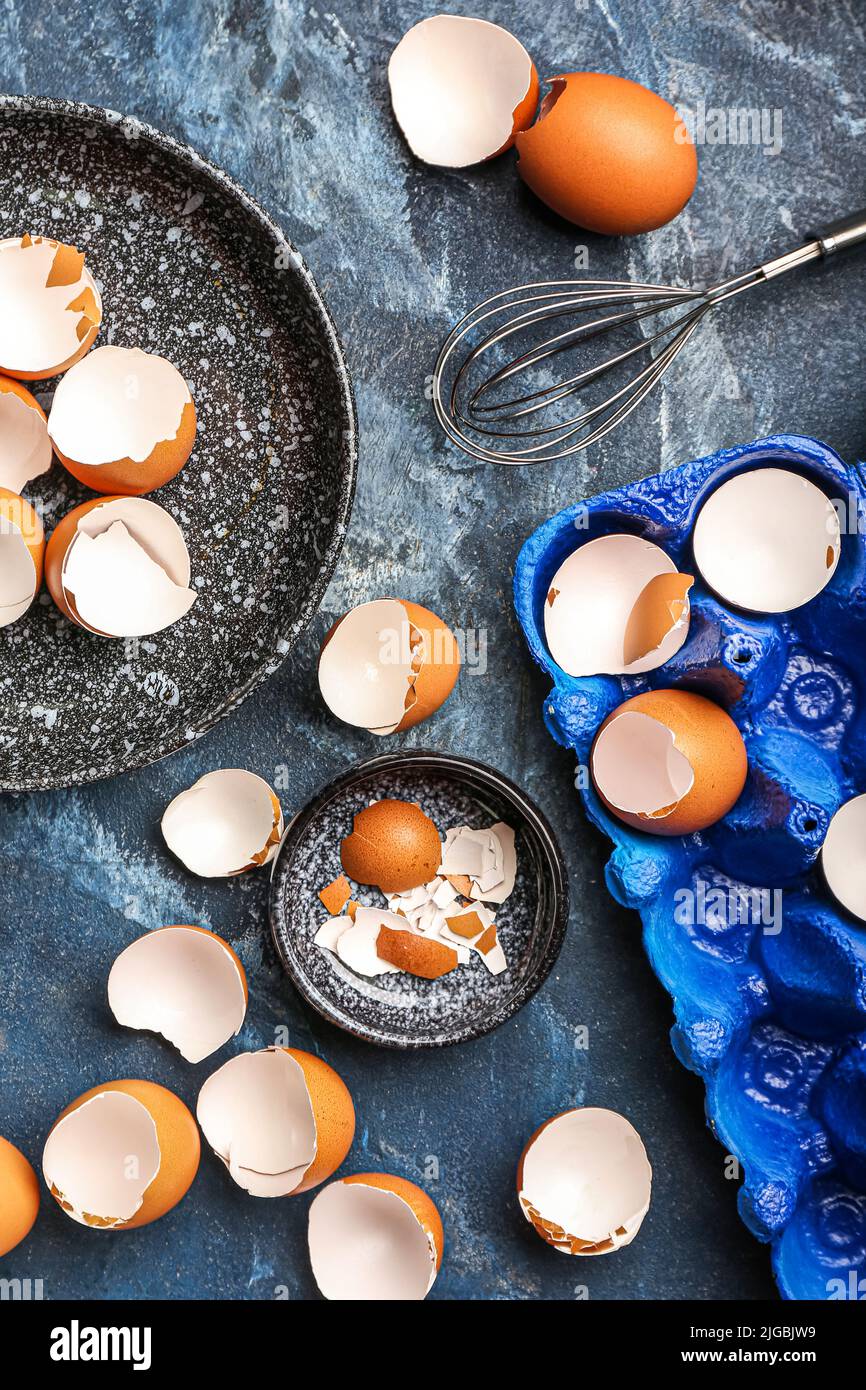 Composition with broken egg shells on color background Stock Photo