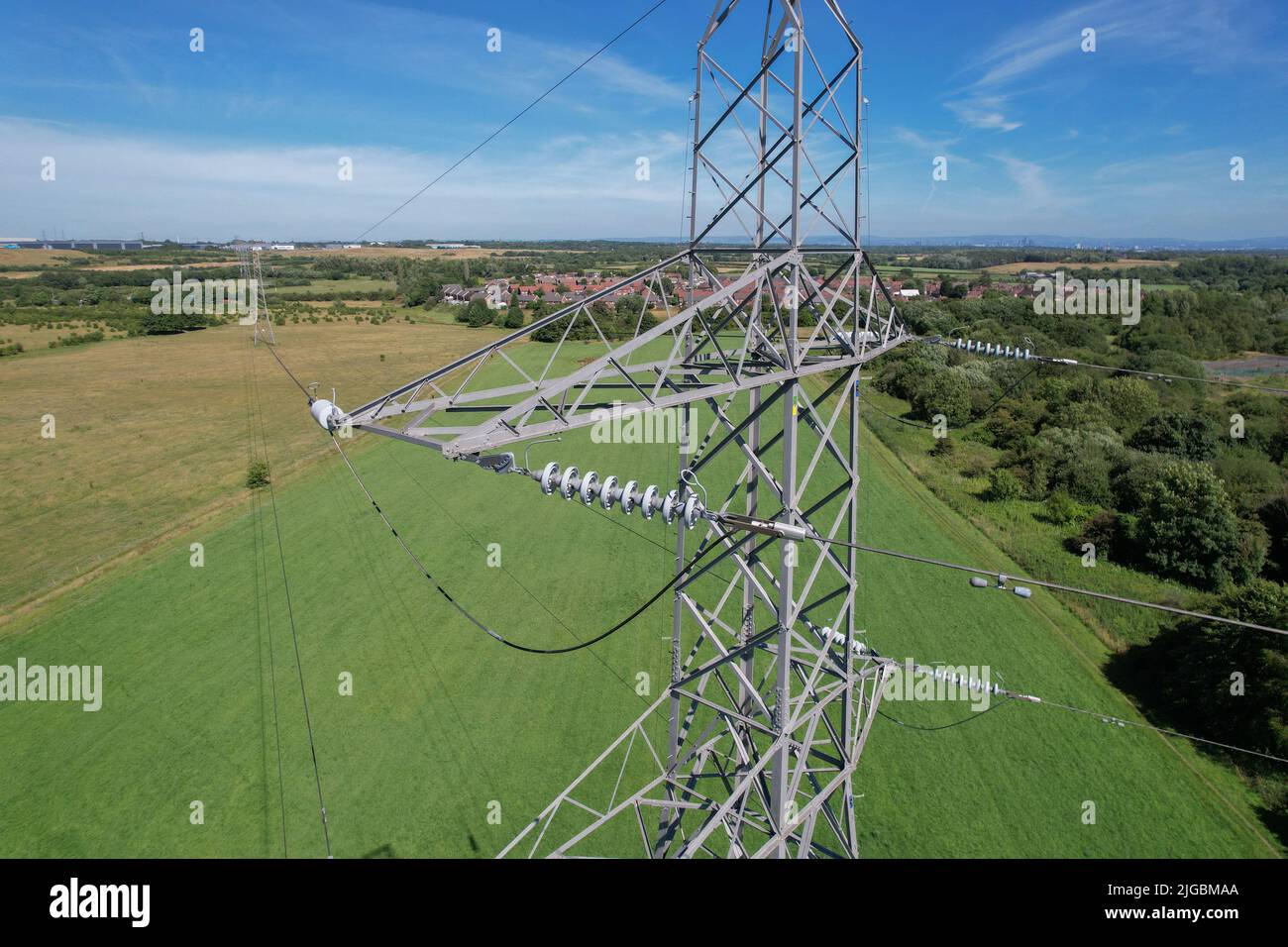 High voltage power line against a blue sky Stock Photo - Alamy