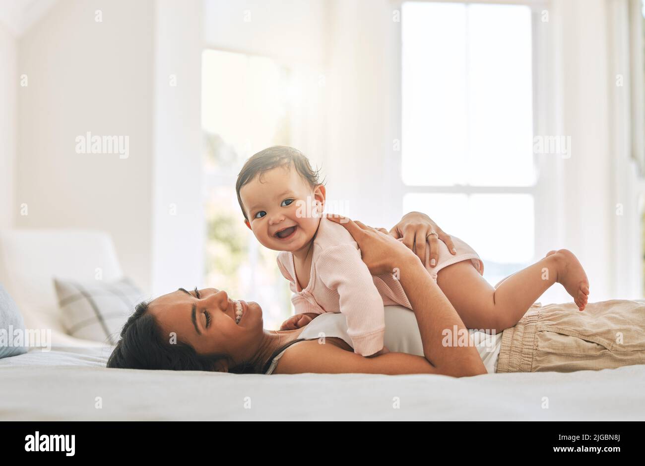 A mothers love. an attractive young woman and her newborn baby at home. Stock Photo