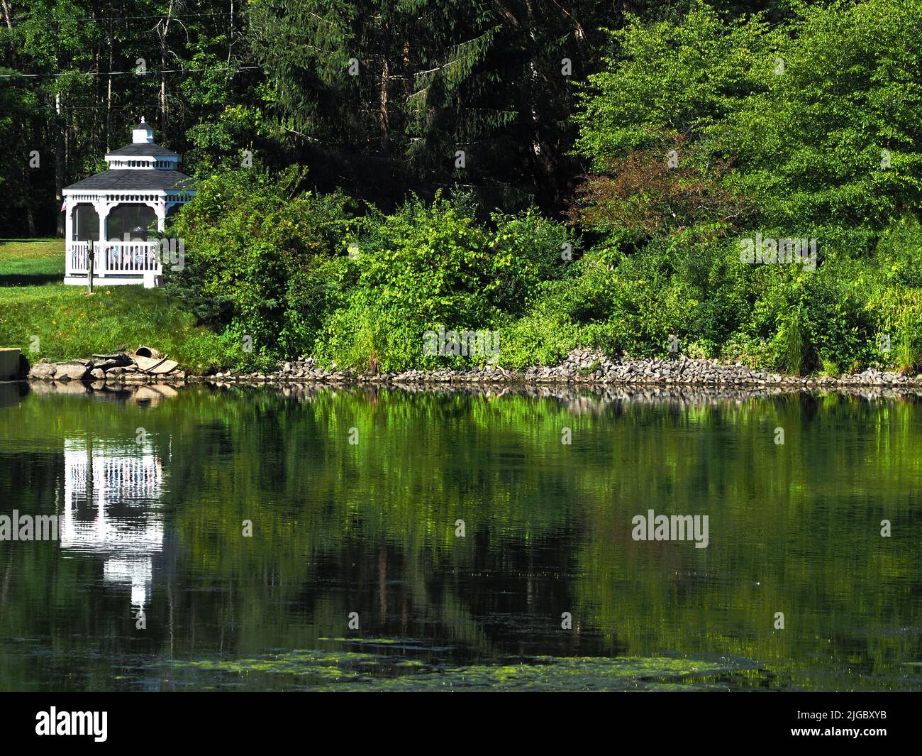 Small white Gazebo on the shore of the Oneida River in Brewerton, New York Stock Photo