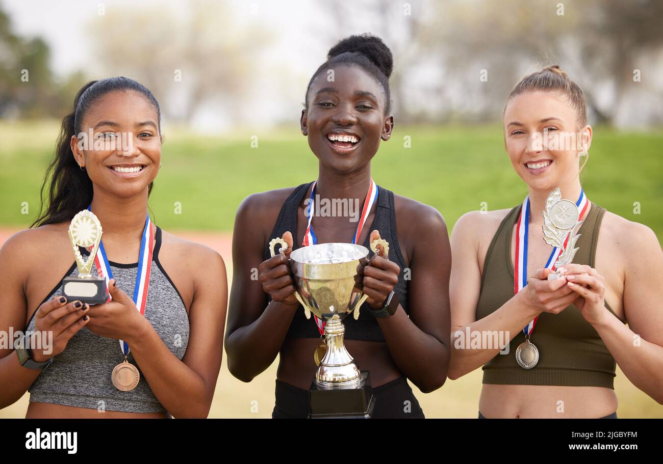 Three women, three winners. Cropped portrait of three attractive young female athletes celebrating their victory. Stock Photo