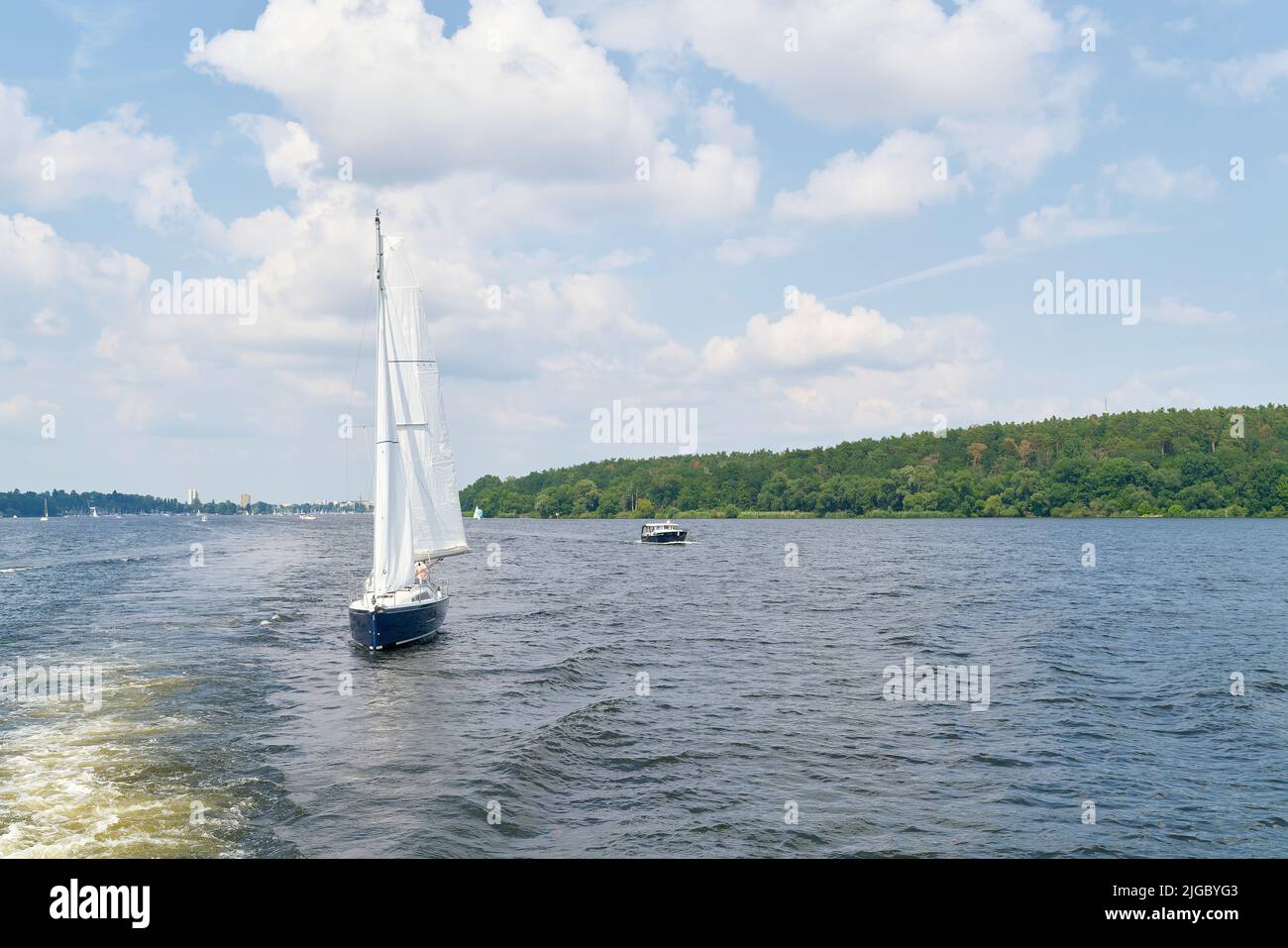 A sailing ship on the Havel river near Berlin. In the background the district of Spandau Stock Photo