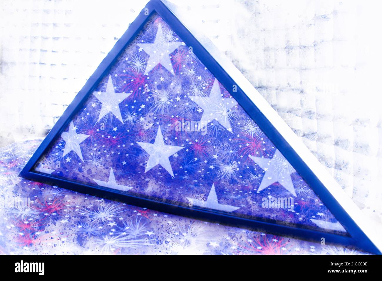 Patriotic American Veteran  military flag in case with fireworks reflecting on glass Stock Photo