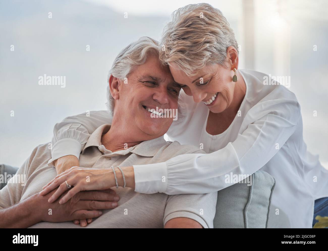 Loving each other more with each passing day. an affectionate senior couple relaxing in their living room at home. Stock Photo