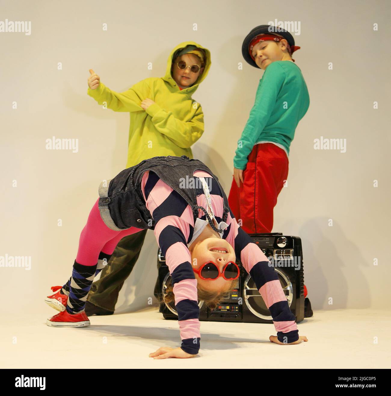 merry kids are breaking dance, hip hop kids, breakdance kids, group of children on a white background Stock Photo