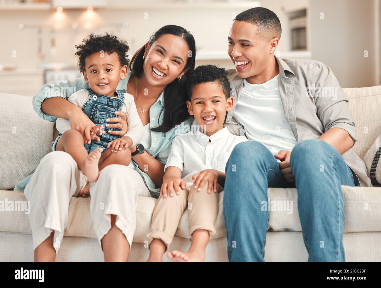 Queen of boys. a young family happily bonding together on the sofa at home. Stock Photo