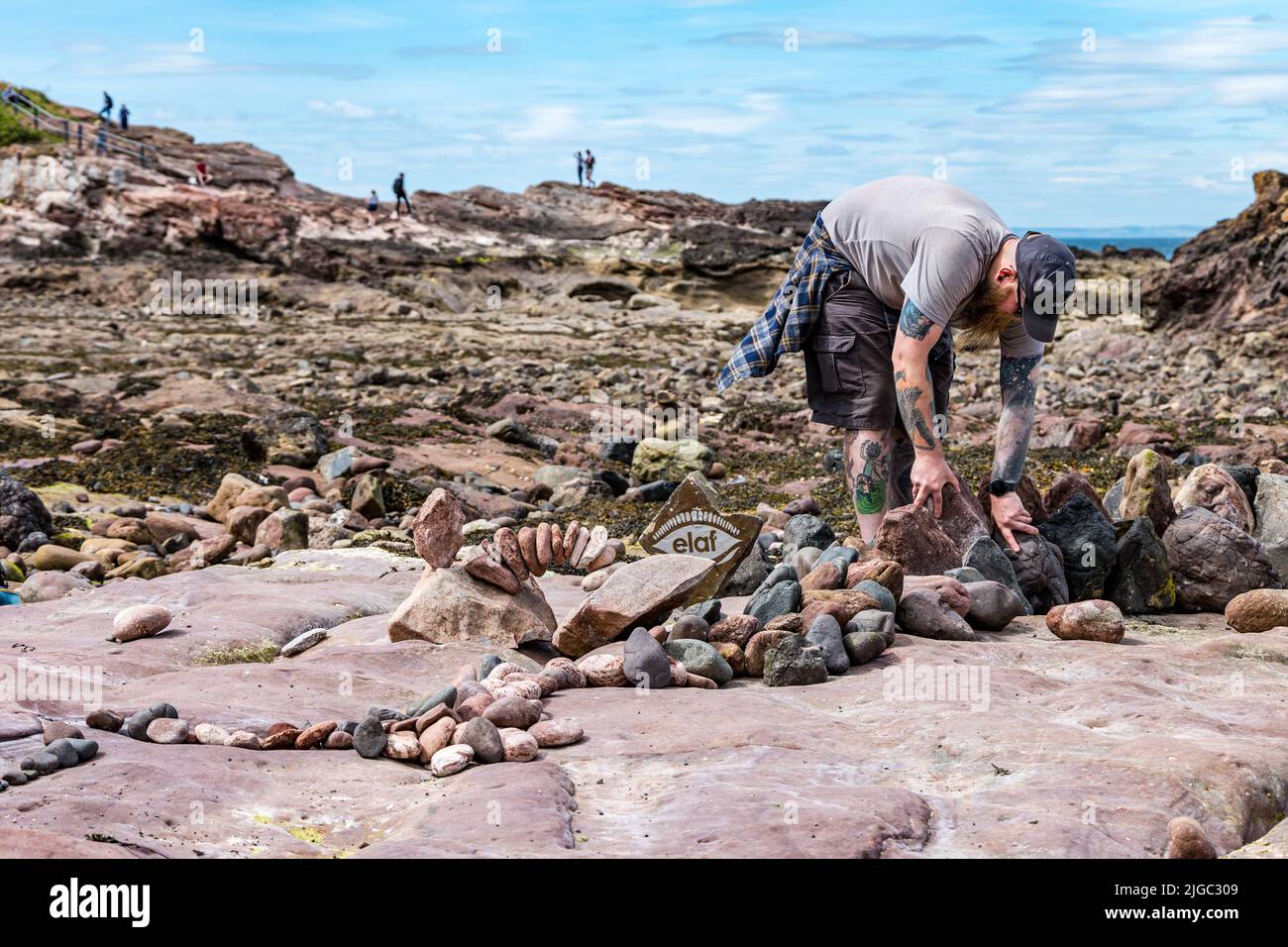 Dunbar, East Lothian, Scotland, UK, 9th July 2022. European Stomne Stacking Championship: participants from all over the world have 3.5 hours to create an artisitic artwork from the rocks on Eye Cave Beach. Credit: Sally Anderson/Alamy Live News Stock Photo