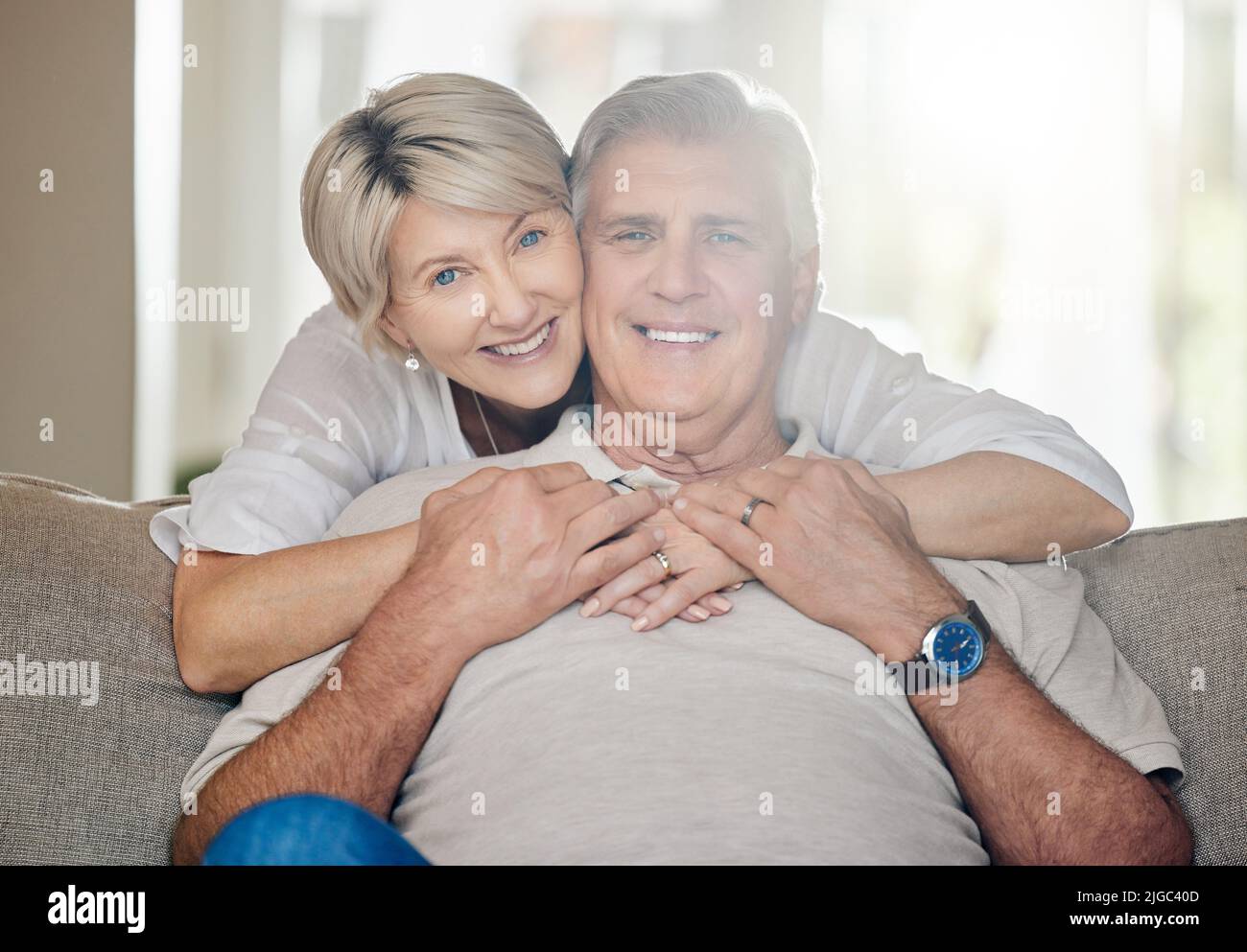 Grandparents are truly irreplaceable. a mature couple sitting on the couch at home. Stock Photo