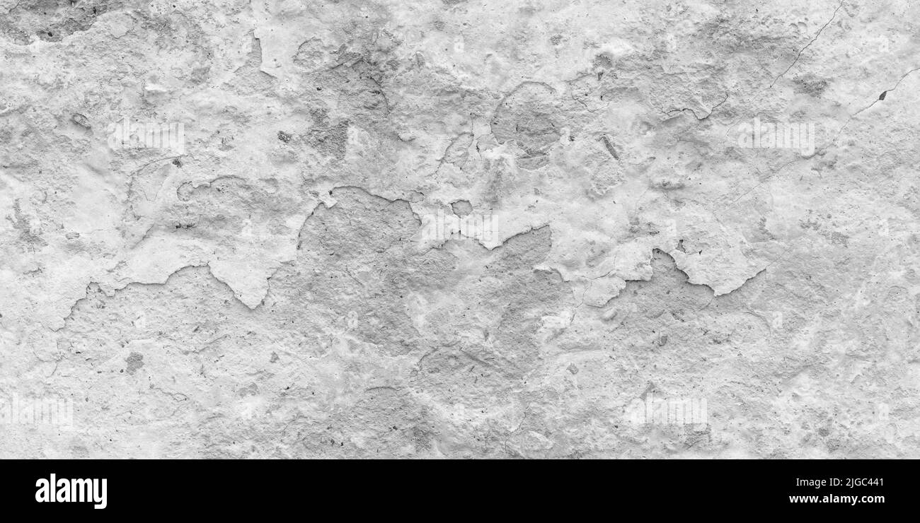 Peeling paint on a gray concrete wall. White painted abstract background, grunge cracked surface, beton pattern texture. Empty space Stock Photo
