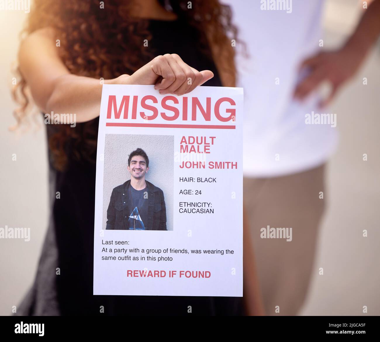 Bring back our loved ones. a woman holding a missing persons flyer. Stock Photo